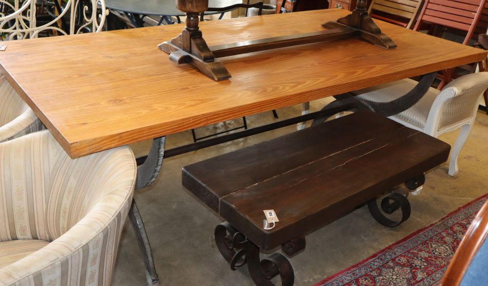 A pine dining table with wrought iron X frame base, W.200cm, D.100cm, H.78cm